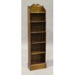 An Edwardian mahogany narrow open bookcase, the gallery inscribed in gilt 'Un livre est un ami qui