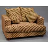 A modern two-seat sofa, upholstered in patterned fabric, on turned feet, height 78cm, width 148cm,