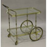 A 20th century gilt brass and glass two-tier hostess trolley, height 78cm, length 80cm.Buyer’s