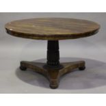 A Regency rosewood circular tip-top breakfast table, raised on a reeded and carved palmette