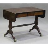 A 20th century Regency style mahogany sofa table with ebony stringing, on lyre supports and sabre