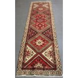 A Hamadan runner, North-west Persia, mid-20th century, the red field with a single column of stepped