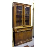 A Victorian mahogany bookcase cabinet, fitted with a pair of arch glazed doors above a single frieze
