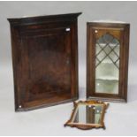 A George II oak and walnut crossbanded hanging corner cabinet, the moulded pediment above a single