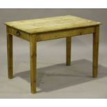 An early 20th century pine side table, the rectangular top above an end drawer, raised on block
