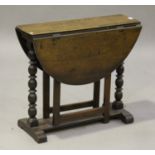 A Victorian oak oval gateleg occasional table, on turned supports and bracket feet, height 68cm,