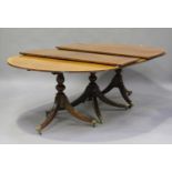 An early 20th century George III style mahogany triple pedestal dining table with boxwood