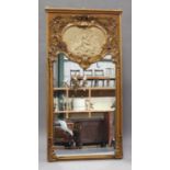 An early 20th century Rococo Revival gilt painted pier mirror with shell and scroll decoration,