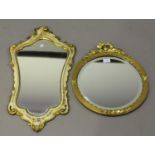 An early 20th century gilt composition circular wall mirror, the reeded frame with laurel wreath