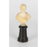 A small mid-19th century carved ivory head and shoulders portrait bust of a gentleman dressed in