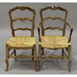 A set of eight 19th century French limed beech ladder back dining chairs, comprising two carvers and