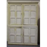 A 19th century white painted pine kitchen cabinet, fitted with four panelled doors enclosing