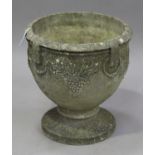 A 20th century cast composition stone garden urn, the ovoid body decorated with bunches of grapes