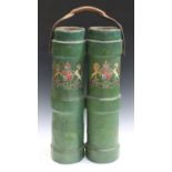 A pair of joined green canvas-covered cylindrical shot buckets, fitted with a leather strap handle