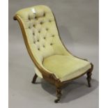 A Victorian mahogany framed salon chair, upholstered in buttoned velour, raised on turned and reeded
