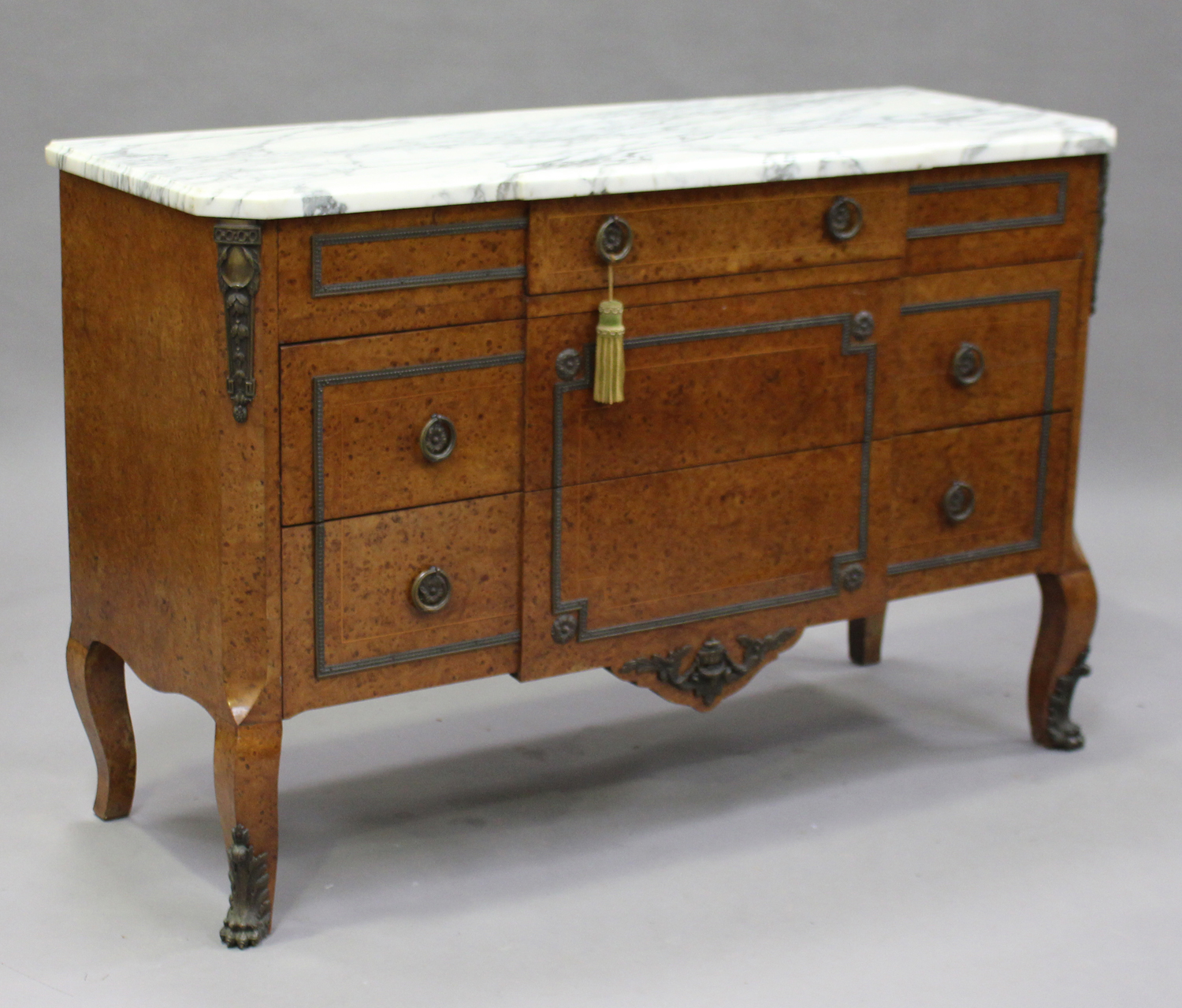 A 20th century French pollard oak commode with gilt metal mounts, the white marble top above three