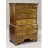 A George I walnut chest-on-chest with feather and crossbanded borders, the cavetto moulded