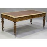 A Victorian oak library table, the moulded top inset with a brown leatherette writing surface,