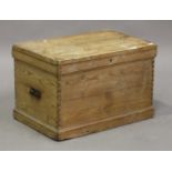 A late Victorian pine trunk with hinged lid and carrying handles, on a plinth base, height 51cm,