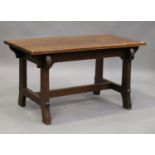 An early 20th century Arts and Crafts stained oak rectangular centre table, raised on shaped