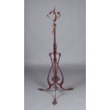 A late Victorian Arts and Crafts painted wrought metal adjustable lamp-standard, converted to