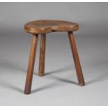 A Robert 'Mouseman' Thompson oak stool, the kidney-shaped seat panel with typical carved mouse