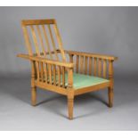 An Edwardian Arts and Crafts oak framed reclining armchair, in the manner of Shapland & Petter,