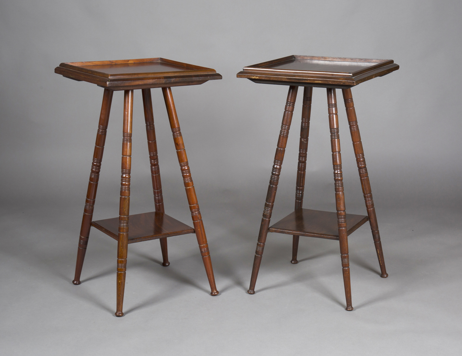 A pair of late Victorian Aesthetic Movement mahogany plant stand/occasional tables, the galleried