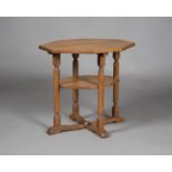 An early/mid-20th century Arts and Crafts oak octagonal two-tier occasional table, in the manner