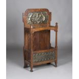 An Edwardian Arts and Crafts oak framed hallstand by Shapland & Petter of Barnstaple, the shaped