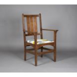 An early 20th century American Mission Arts and Crafts oak framed armchair, designed by Harvey Ellis