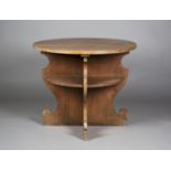 A late 20th century Arts and Crafts style oak two-tier circular centre table, retailed by James