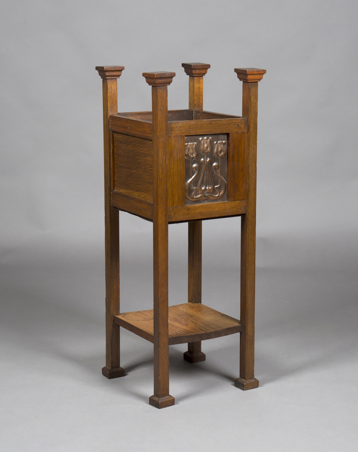 An Edwardian Arts and Crafts oak framed planter, in the manner of Shapland & Petter of Barnstaple,