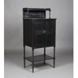 A late Victorian Aesthetic Movement ebonized side cabinet, the mirror shelf back above a pair of