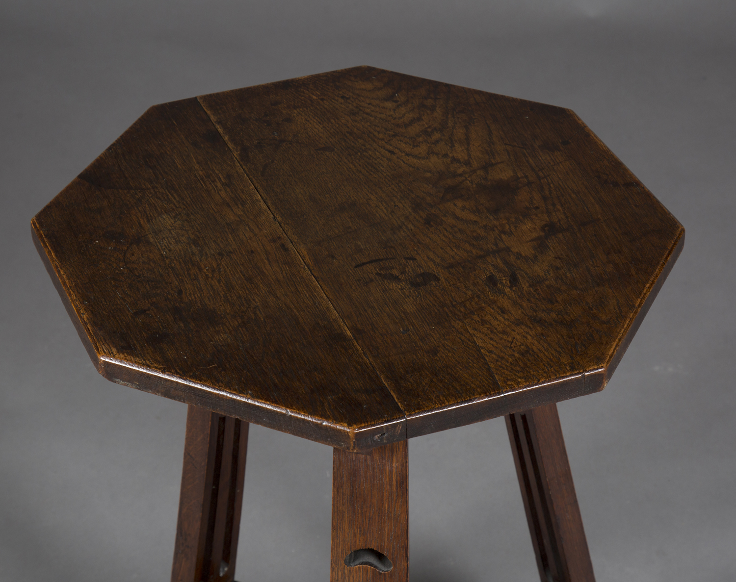 An Edwardian Arts and Crafts oak octagonal two-tier occasional table, probably by Liberty & Co, - Image 2 of 2