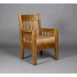 An early 20th century American Mission Arts and Crafts oak framed armchair, probably made by