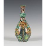 A Della Robbia Pottery bottle vase, circa 1900, painted with flowering stems of geranium against