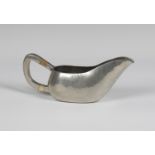 An early 20th century German Urach hammered pewter gravy boat, designed by the Bauhaus student