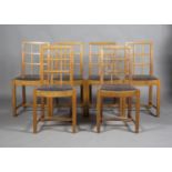 A set of six early 20th century Arts and Crafts oak lattice back dining chairs, probably by Heals,