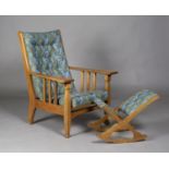 An Edwardian Arts and Crafts oak framed reclining armchair by James Shoolbred & Co, the buttoned