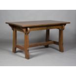 An early 20th century Arts and Crafts stained oak rectangular centre table, raised on shaped