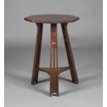 An Edwardian Arts and Crafts oak octagonal two-tier occasional table, probably by Liberty & Co,