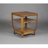 An early 20th century oak three-tier occasional table, in the manner of Heals, the canted square top