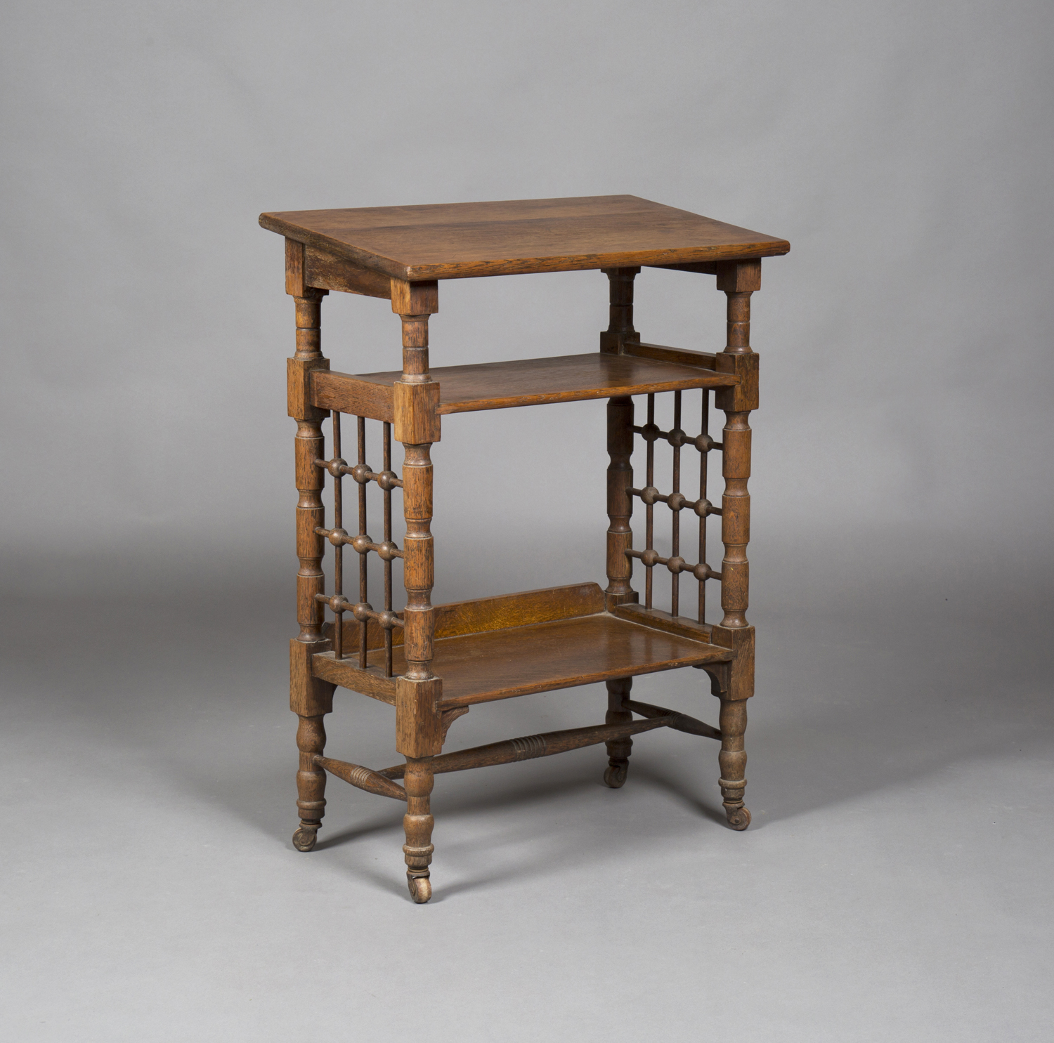 An Edwardian Arts and Crafts oak reading table, designed by Leonard Wyburd for Liberty & Co, the