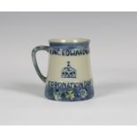 A Moorcroft pottery commemorative mug, circa 1902, of tapered cylindrical shape, commemorating the