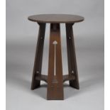An Edwardian Arts and Crafts stained oak circular occasional table, in the manner of Liberty & Co,