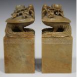 A pair of Chinese carved soapstone figures of fenghuang (phoenix), early 20th century, each