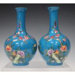 A pair of Chinese famille rose blue ground porcelain bottle vases, mark of Yongzheng but early