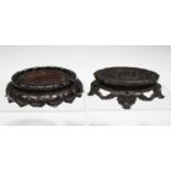 A Chinese hardwood stand, late Qing dynasty, the oval top with finely carved and pierced central
