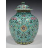 A Chinese famille rose enamelled turquoise ground porcelain jar and cover, 19th century, the stout